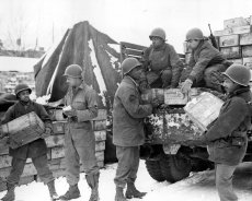 Black soldiers of the Quartermaster Corps ship rations to the front lines.
