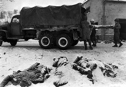 A graves registration team retrieves the dead during the Battle of the Bulge.